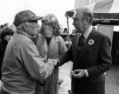 Governor Carey shakes hands with a spectator 