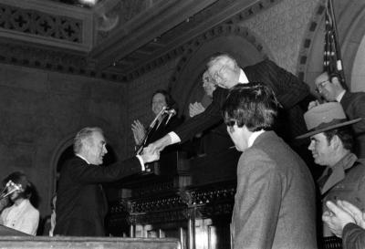 Governor Carey Shakes Hands with Warren M. Anderson