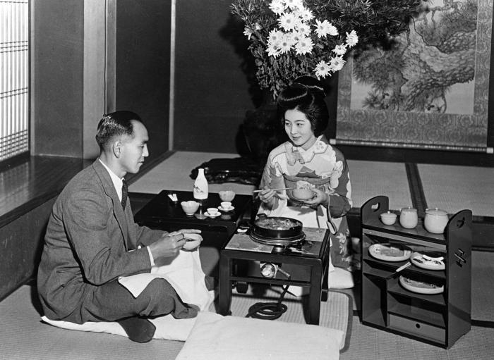 Japanese Girl Serving "Sukiyaki" Cooked in Electric Grill. Japan