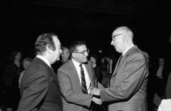 Governor Carey and Commissioner David Axelrod greet Howard Miller