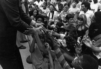 People Reaching up to Governor Carey 