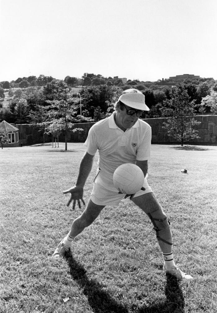 Hugh Carey serving a volleyball