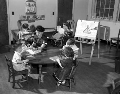 Woman in class with six recovering children, 1954