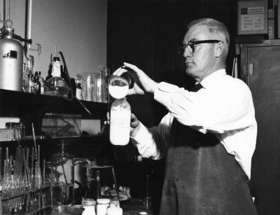 Scientist mixing liquids in a lab