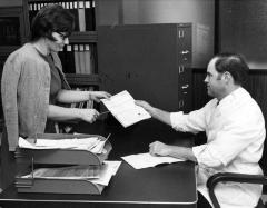 Scientists looking over a document