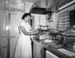 Woman with scientific equipment and test tubes, 1959