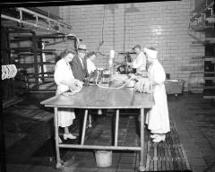 Workers Around Table Making Sausages