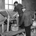 Agricultural workers using a grinding machine