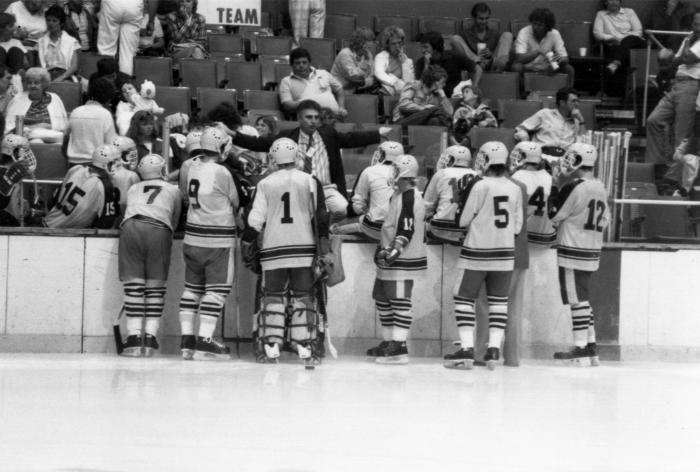 Men's ice hockey team with coach at the Empire State Games