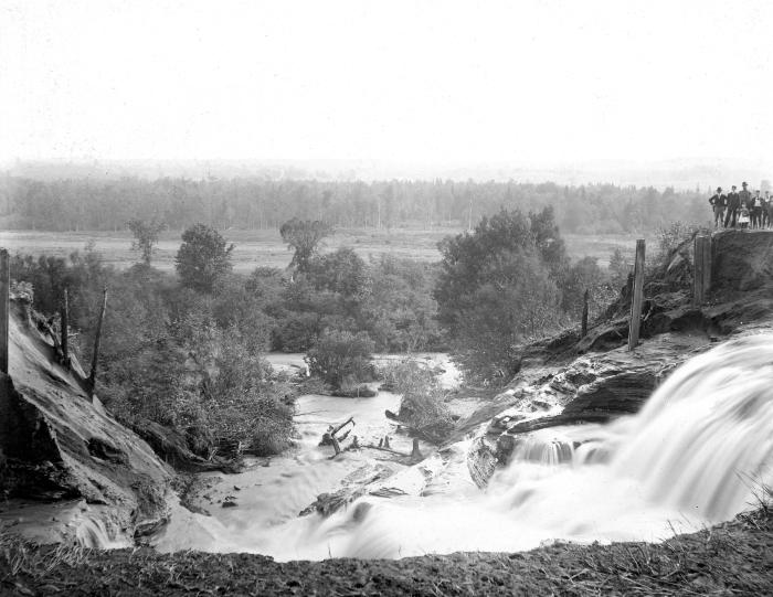 Water rushes through a break in the Forestport Feeder canal levee, 1899