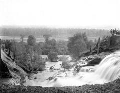 Water rushes through a break in the Forestport Feeder canal levee, 1899