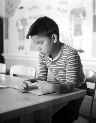 Thomas Indian School Photograph.  Young Boy with Textbook