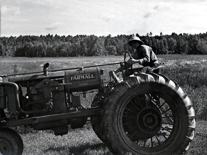 Thomas Indian School Photograph, No. 116, Male Student on a Tractor