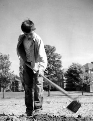 Thomas Indian School Photograph.  Young Boy Tilling Soil