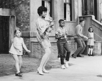 Susan and Bob dancing with children on Sesame Street