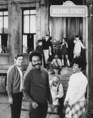 Sesame Street adult cast and group of children standing outside of 123 Sesame Street
