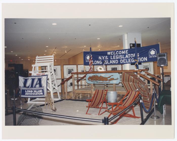 Indoor beach scene set and banner reading: Welcome NYS Legislators Long Island Delegation