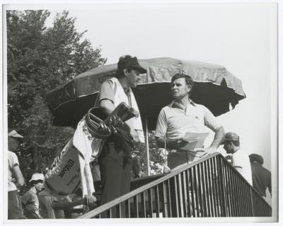Two men, one with golf clubs. Long Island PGA Tournament. Bethpage State Park