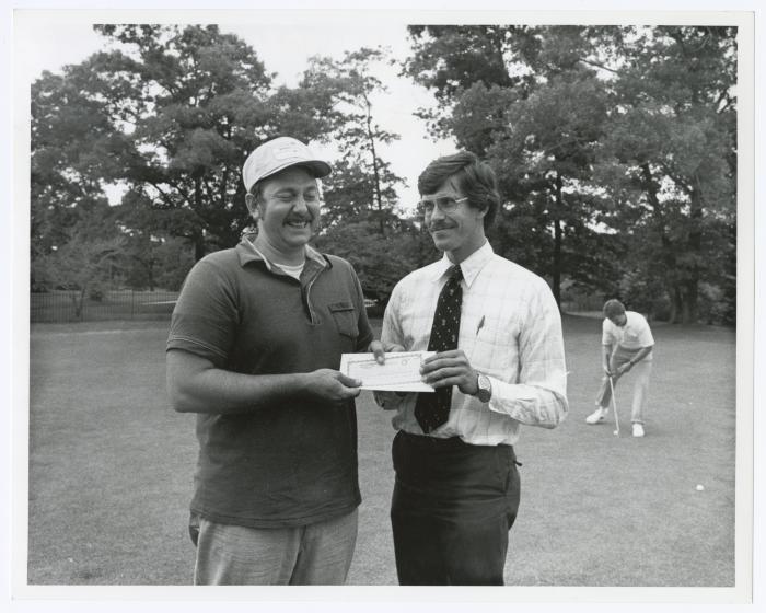 Image of man presenting check to another man. Sunken Meadow State Park Bank of New York Golf