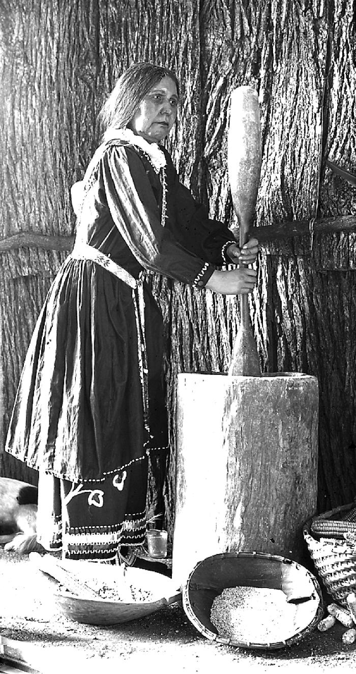 Iroquois [Haudenosaunee] woman making corn meal