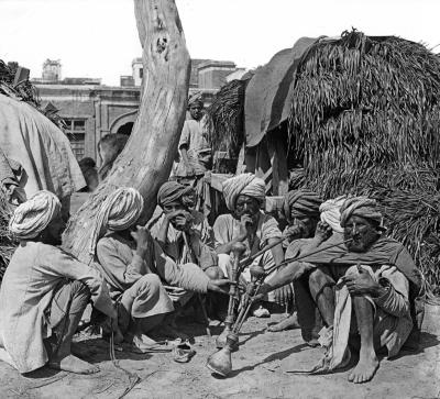 Sikh Forage Dealers Enjoying their Hookahs in the Grass Market. Amritsar, India