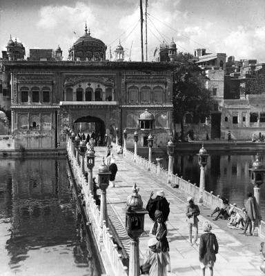 Entrance Gate to the Golden Temple from water side; Causeway and People. Amritsar, India