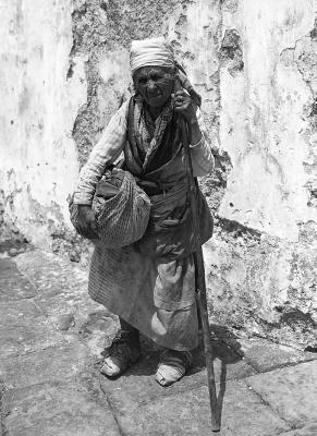 Italy.  Amalfi.  Old Woman from the Country, with Staff, Bag and Bundle, Feet Wrapped in Rags