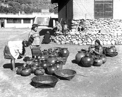 Philippine Islands.  Luzon.  Bontoc.  Filipino Women with Pottery Jars for Sale