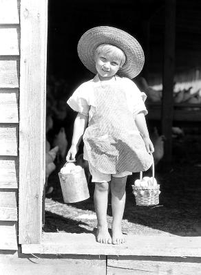 Small girl carrying basket of fresh eggs, Newnan, Georgia