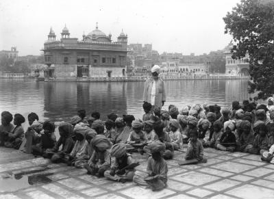 Sikh Teacher with Class of Boys by the Tank of the Golden Temple. Amritsar, India