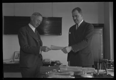 Com'r Osborne and Wm. G. Howard.  Holding Check Received from Empire Fuel Co., as Royalty on Gas Well