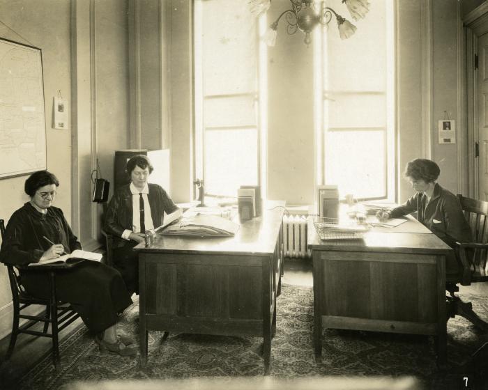 Three Department of Health  workers in a sunlit room, 1924