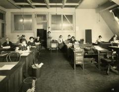 Eleven office workers at their desks, 1924