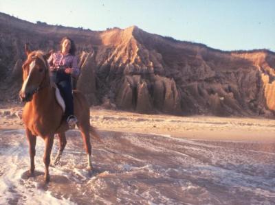 Long Island, woman riding a horse on a beach