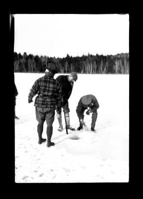 Preparing Hole in Ice for Tip-Up Fishing Through the Ice.  Long Pond Near Crafton, Rensselaer County.