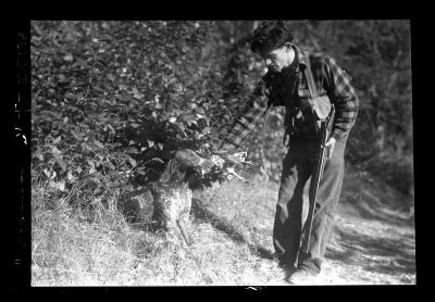 Art Cook with German Short Hair Dog Who Has a Grouse in Mouth