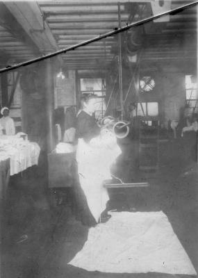 Women tending machines - material (?) on floor, no. 2