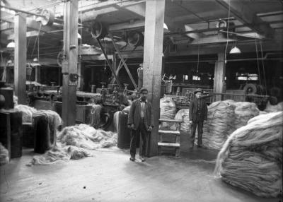 Interior of machine room:  processing run, possibly for hemp, piles of material