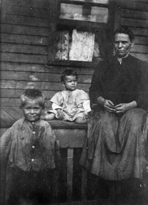 Woman and two children on porch