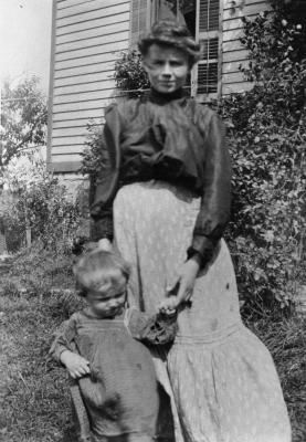 Woman and child outside home