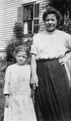 Woman and child outside home