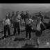 Group of hikers stand atop a mountain in the Adirondacks