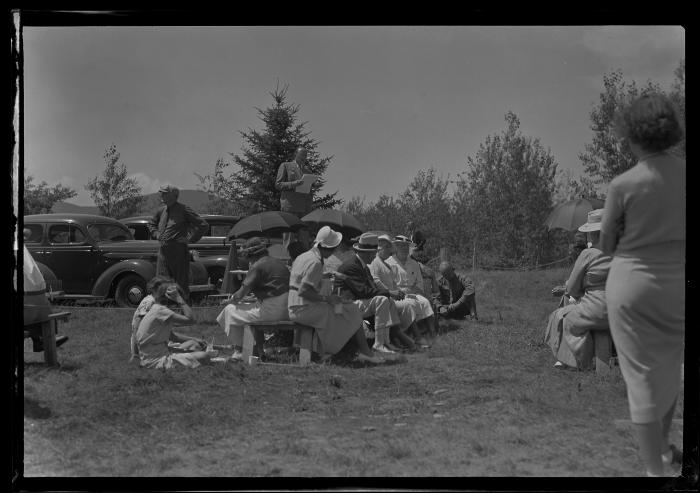 People sit and eat at the dedication of the Cumberland campsite