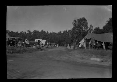 Families park and pitch tents at a public campsite along the St. Lawrence River