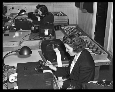 Women testing accuracy of clock parts. Waterbury Watch and Clock Company. Waterbury, Connecticut