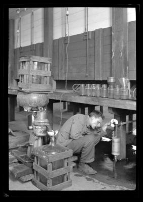 Worker adjusts a valve at the Bayville Bridge experimental shellfish hatchery