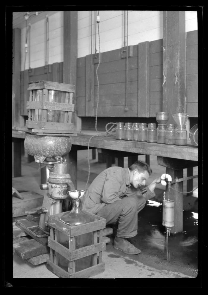 Worker adjusts a valve at the Bayville Bridge experimental shellfish hatchery