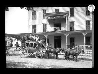 Travelers posing in front of the Wells House