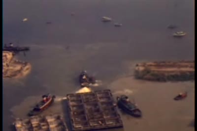 Thruway aerial shots of giant caissons being floated out of natural dry dock at Grassy Point, 1953
