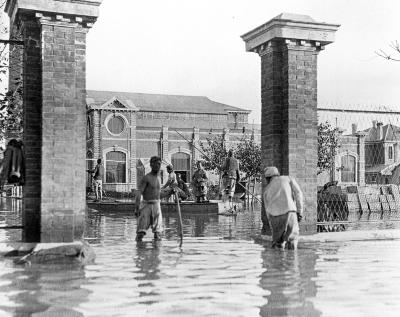 Flooded street, man poling a boat, Tientsin, China